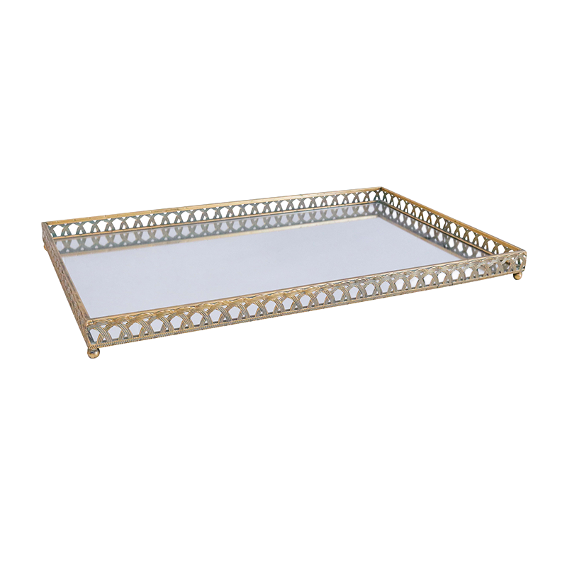 Decorative tray with gold metal frame and white glass surface on a white background