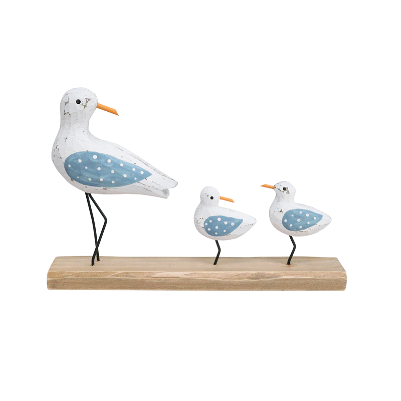 Decorative figurines of seagulls on a wooden base