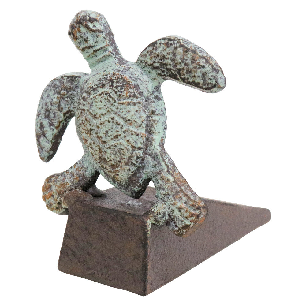 Metal turtle doorstop with a weathered green finish, textured detailing and a rustic brown wedge base.
