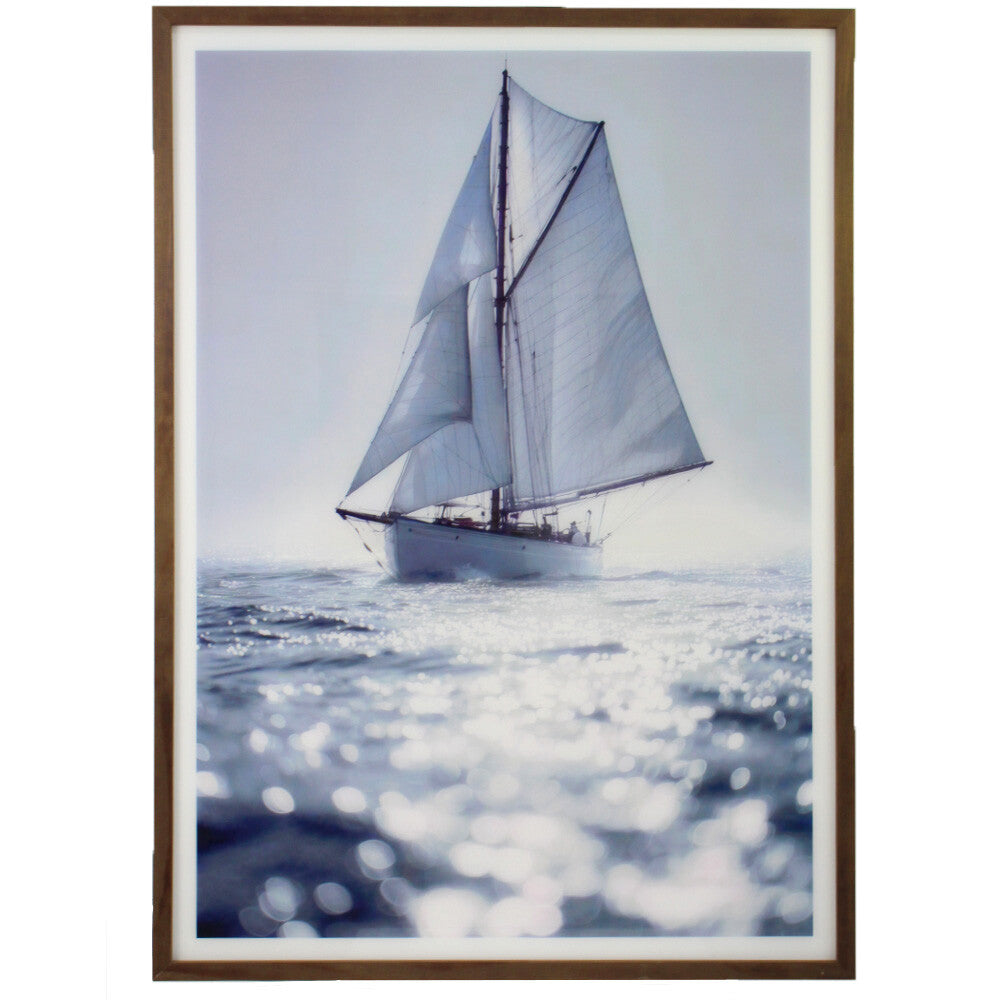 Solo Sailing framed artwork above a timber console in a coastal living room with a linen armchair and soft afternoon light.