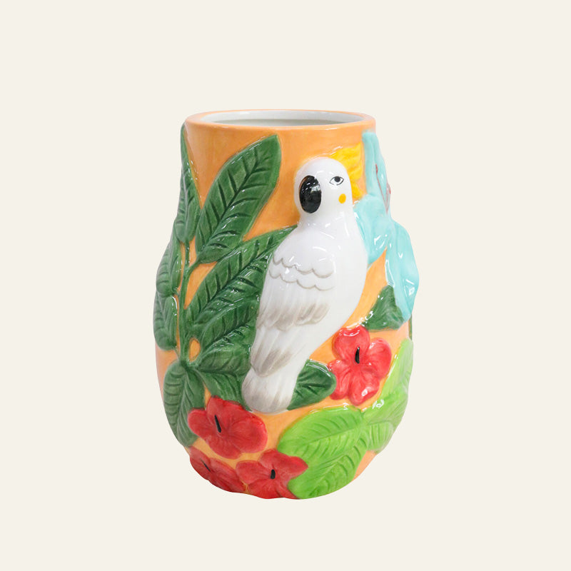 Hand-painted orange ceramic vase with a raised white cockatoo, green tropical leaves and red hibiscus flowers.- view 2