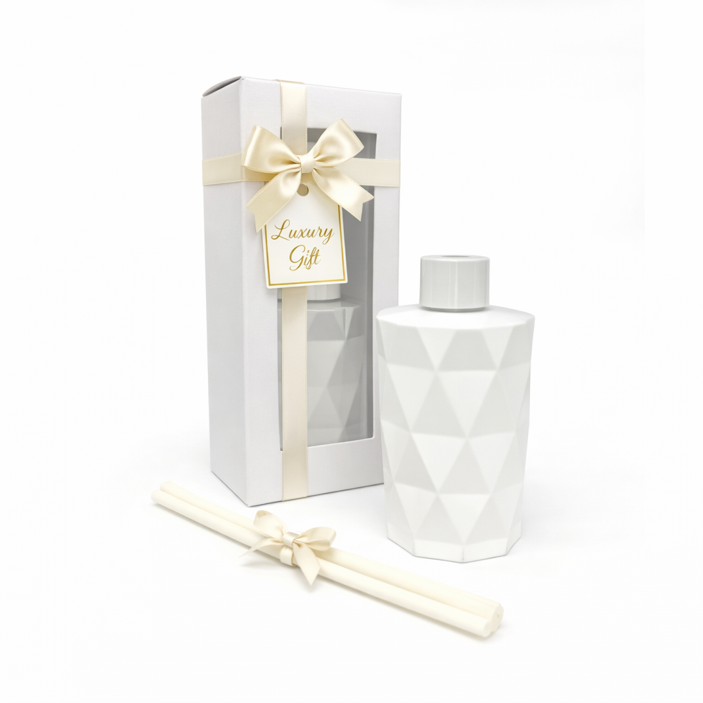 White geometric bottle with matching box and candle on a white background