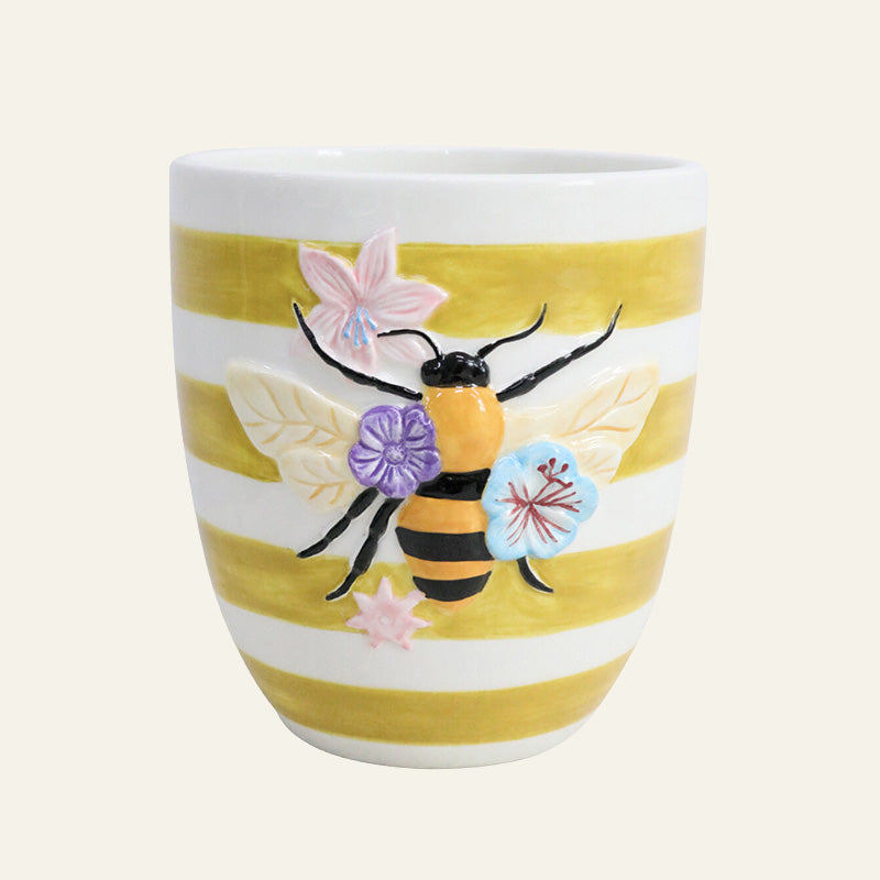 Ceramic planter with yellow and white stripes, raised bee design and pastel flower details.