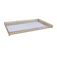 Decorative tray with gold metal frame and white glass surface on a white background