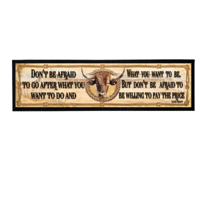 Decorative sign with a bull's head and motivational quote on a white background