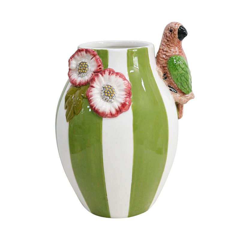 Ceramic vase with green and white stripes, floral design, and parrot figurine 