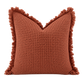Terracotta organic waffle cushion cover with textured weave and frayed edge detail