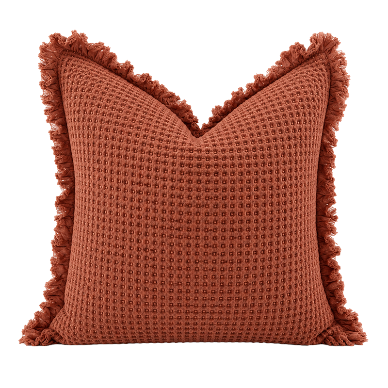 Terracotta organic waffle cushion cover with textured weave and frayed edge detail
