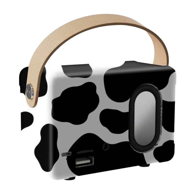 Portable cow print Bluetooth speaker with carry handle and side speaker detail.