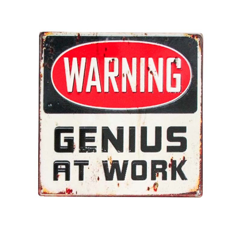 Vintage-style coaster with 'Warning: Genius at Work' text on a white background