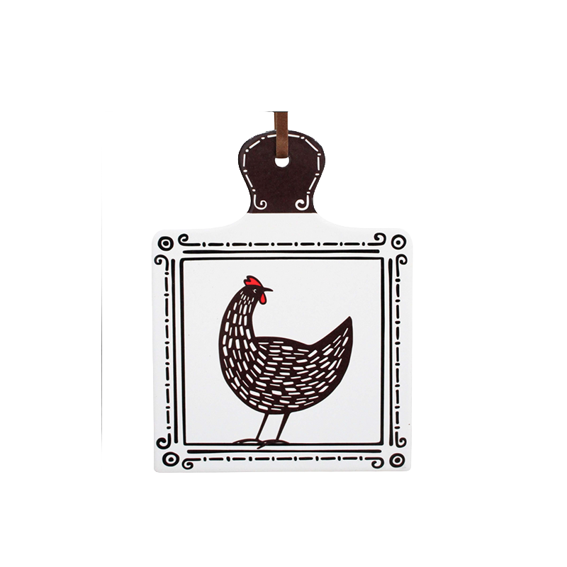 Ceramic trivet featuring a black and white hen illustration with red comb detail and cork backing.