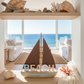 Decorative shelf with beach-themed items in a room with ocean view