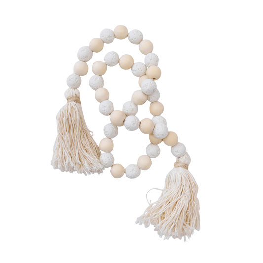 Decorative string of white stone and pink wooden beads with tassels o