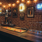 XXXX bar mat on bar counter with glasses and a beer pump