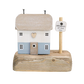 Decorative house on a wooden base with a sign reading 'Dreaming of the Sea' 