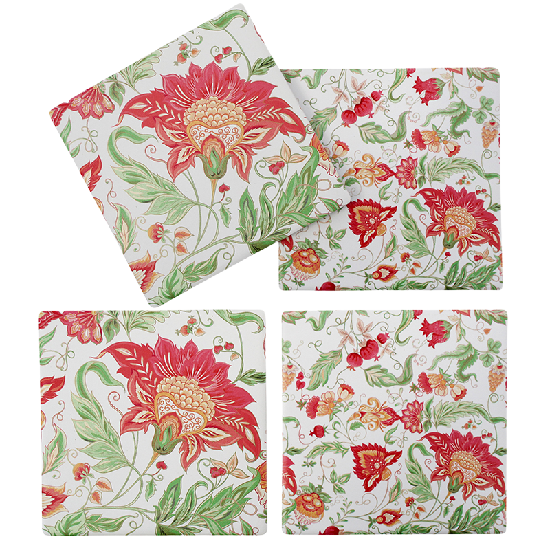 Set of four floral-patterned coasters on a white background