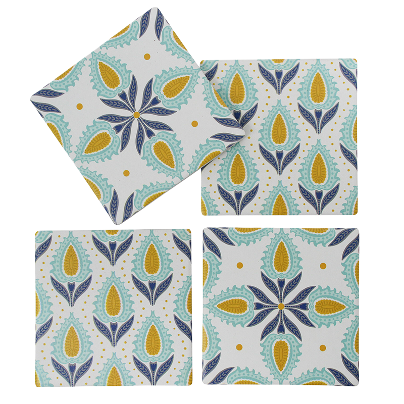 Set of four coasters with a floral pattern on a white background