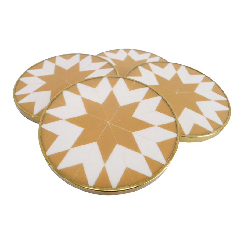 Set of four round coasters with a tan geometric pattern on a white background
