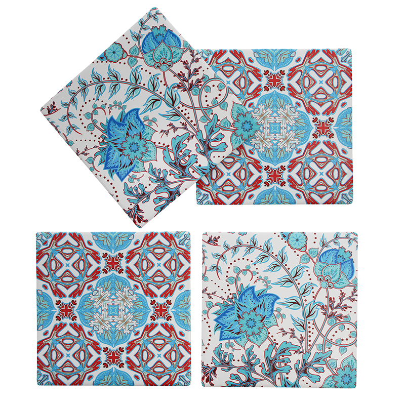 Set of four porcelain coasters with floral and geometric patterns on a white background
