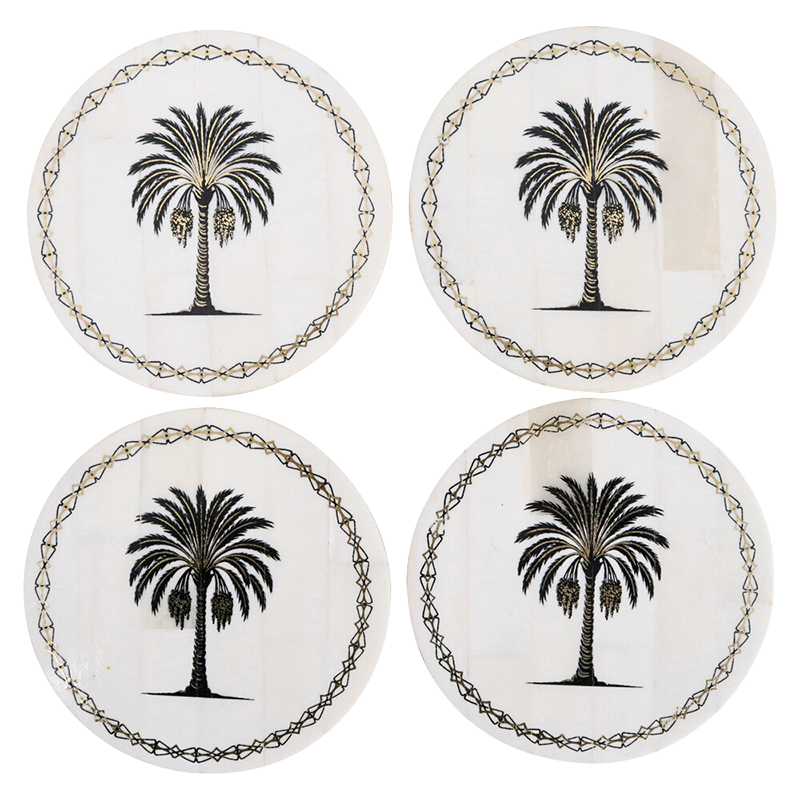 Four coasters with palm tree design on a white background