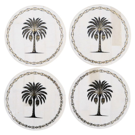 Four coasters with palm tree design on a white background