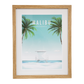 Framed artwork of Malibu, California with palm trees and a beach scene.