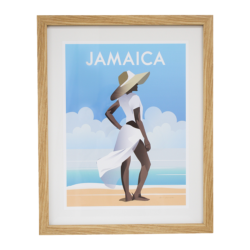 Framed artwork of a woman in a white dress and sun hat on a beach with 'Jamaica' text.