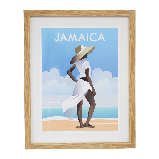 Framed artwork of a woman in a white dress and sun hat on a beach with 'Jamaica' text.