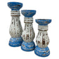 Three distressed wooden candle holders in a tiered arrangement, featuring a blue and white paint finish with visible brown wood grain underneath, set against a plain white background.