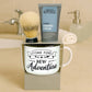 A boxed grooming gift set on a beige countertop in a bathroom setting, featuring a white ceramic mug with the phrase 'TIME FOR NEW Adventure,' a gray tube of Men's Republic shaving cream, and a shaving brush resting on top of the box.