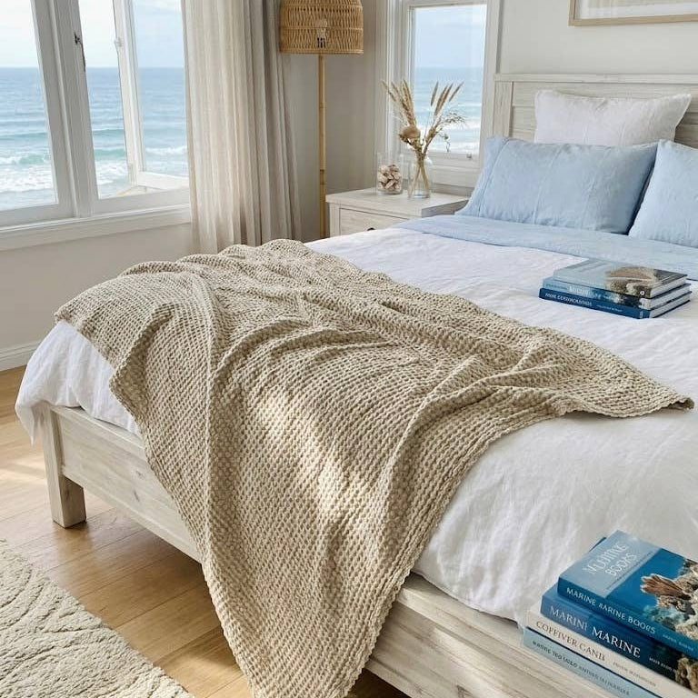 Natural organic cotton and bamboo waffle throw layered across a white bed
