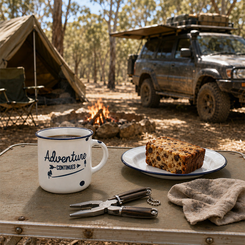 Adventure Continues mug with coffee, fruit cake and folding pliers at an Australian bush campsite