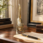 Gold solid brass monkey sculpture in a crouching pose with a curled tail sat on desk