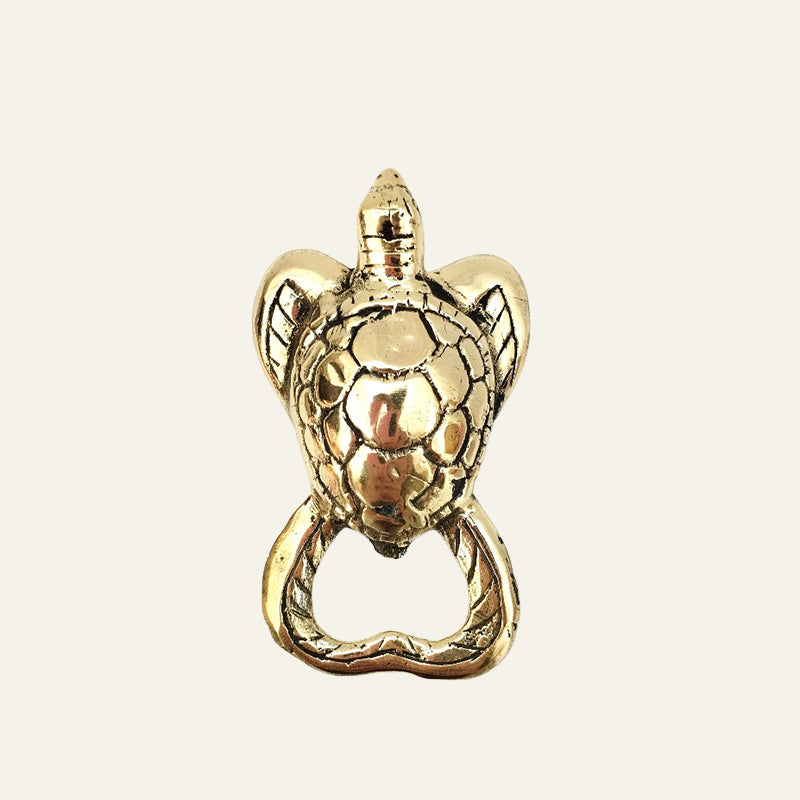 Brass turtle-shaped bottle opener with detailed shell design.