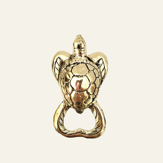 Brass turtle-shaped bottle opener with detailed shell design.