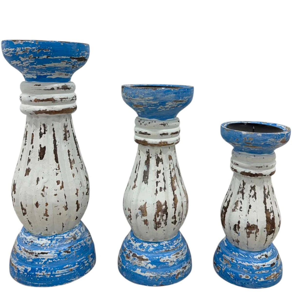 Three distressed wooden candlestick holders in a tiered set, featuring a rustic white and blue paint finish with visible brown wood showing through.
