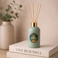 Green diffuser bottle on a stack of books 