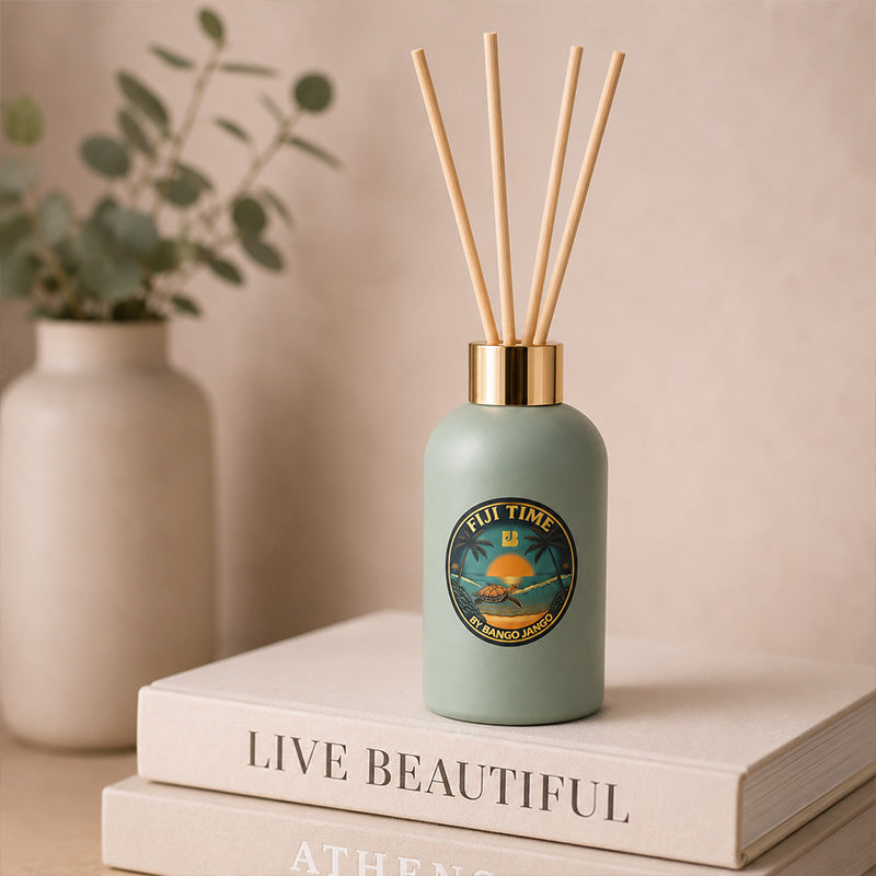 Green diffuser bottle on a stack of books 
