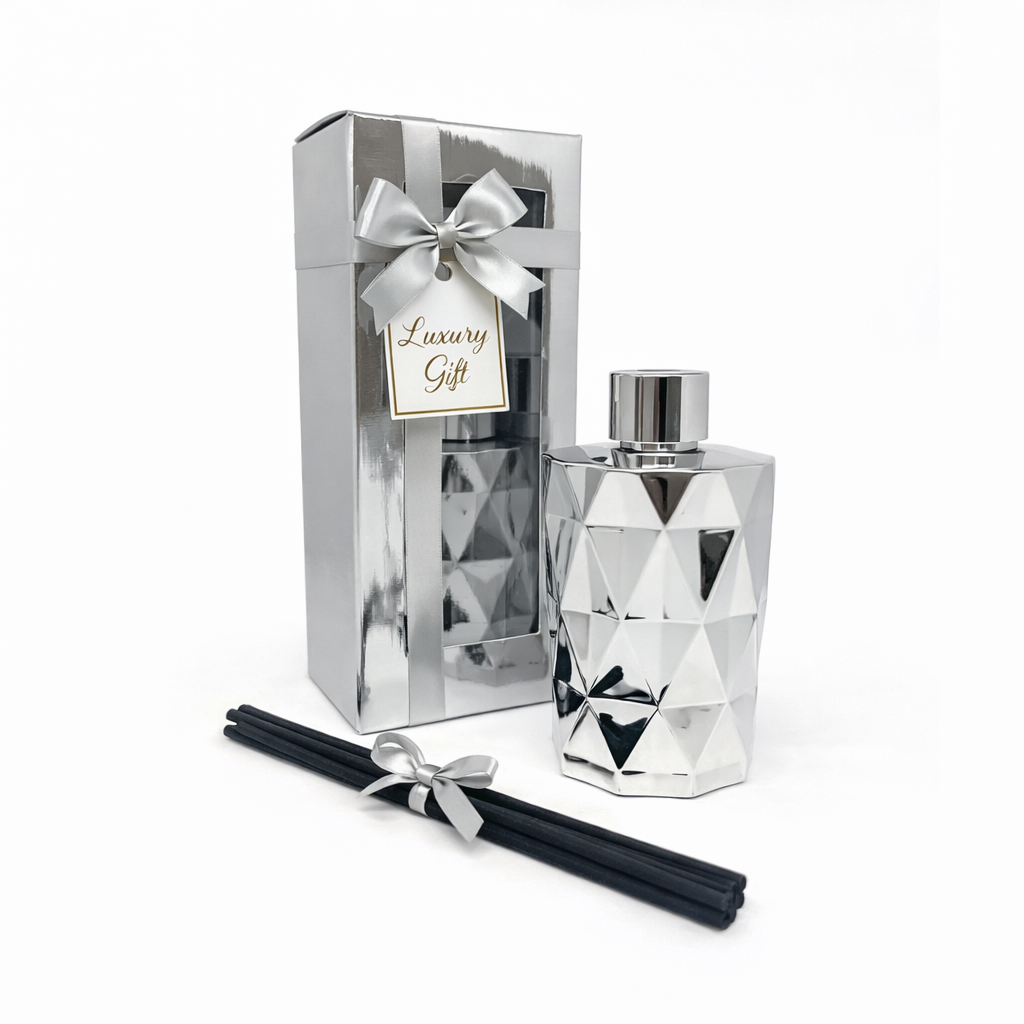 Luxury diffuser set with geometric design, packaging, and black sticks on a white background