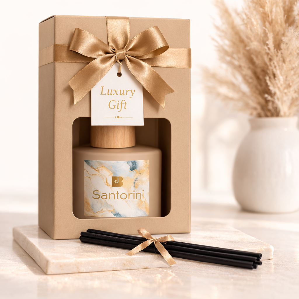 Gift set with a candle labeled 'Santorini' in a decorative box with a gold bow.