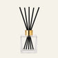 Kairo Clear glass diffuser bottle with black sticks and gold cap 