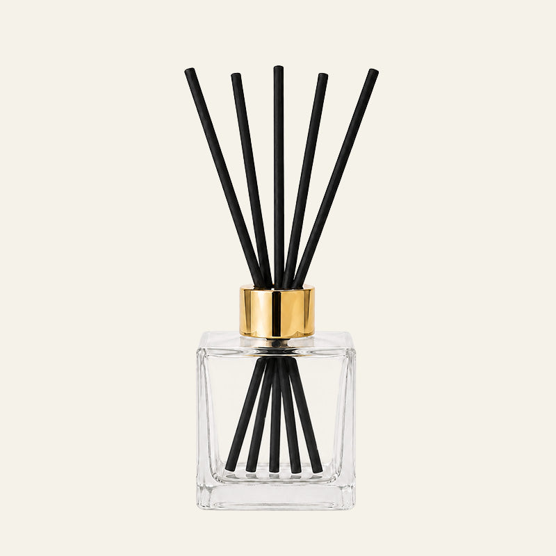 Kairo Clear glass diffuser bottle with black sticks and gold cap 