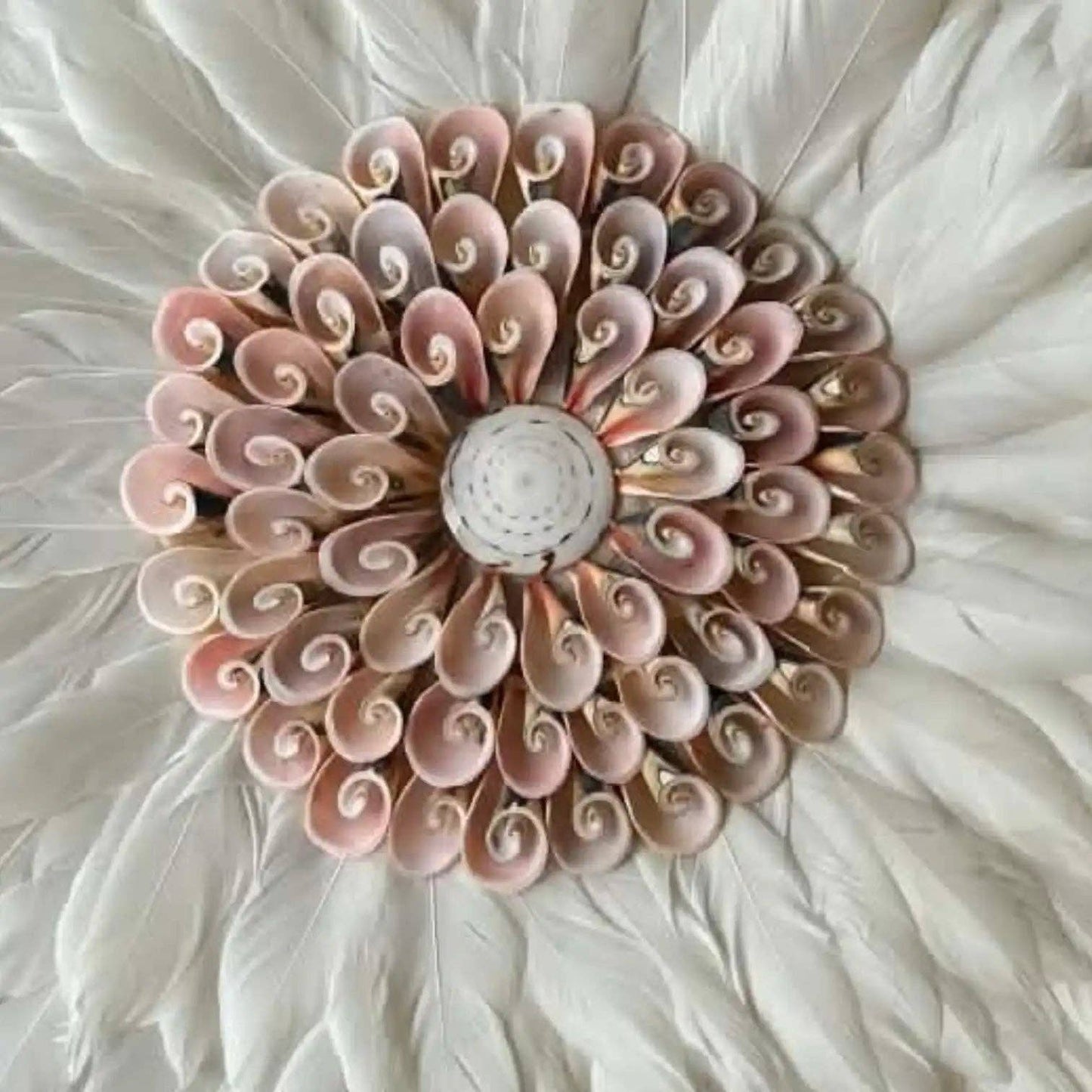 Decorative wall art with pink and beige swirl patterns on a white background