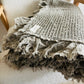 Add earthy colour and relaxed texture with this khaki waffle throw blanket, made from organic cotton and finished with soft frayed ruffle edging.