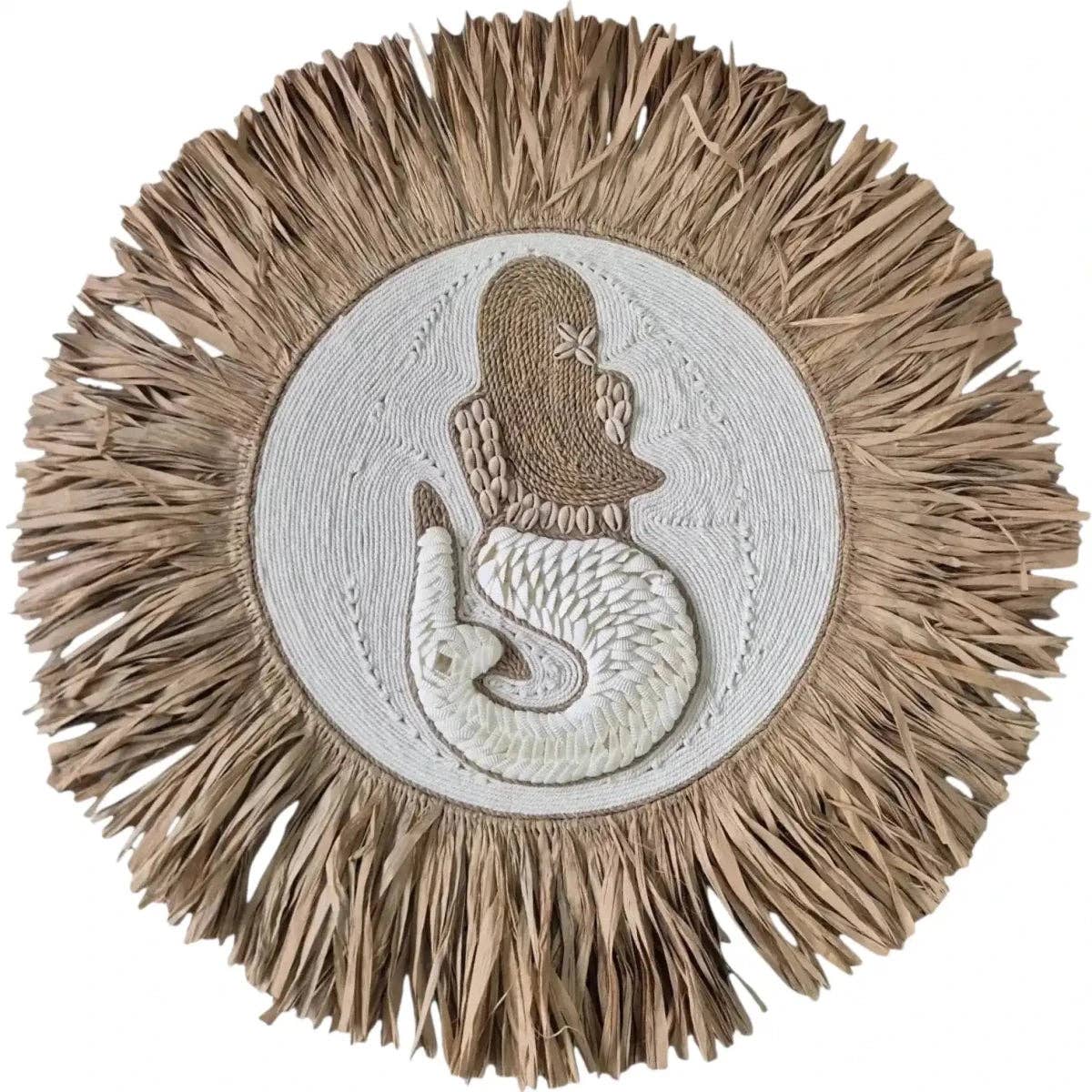 A circular woven wall hanging or decorative plaque featuring a mermaid motif. The design has a natural tan raffia or straw fringed border surrounding a central off-white circular panel with a raised tan mermaid figure.