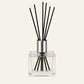 Heavy clear glass diffuser bottle with tall silver collar and black sticks