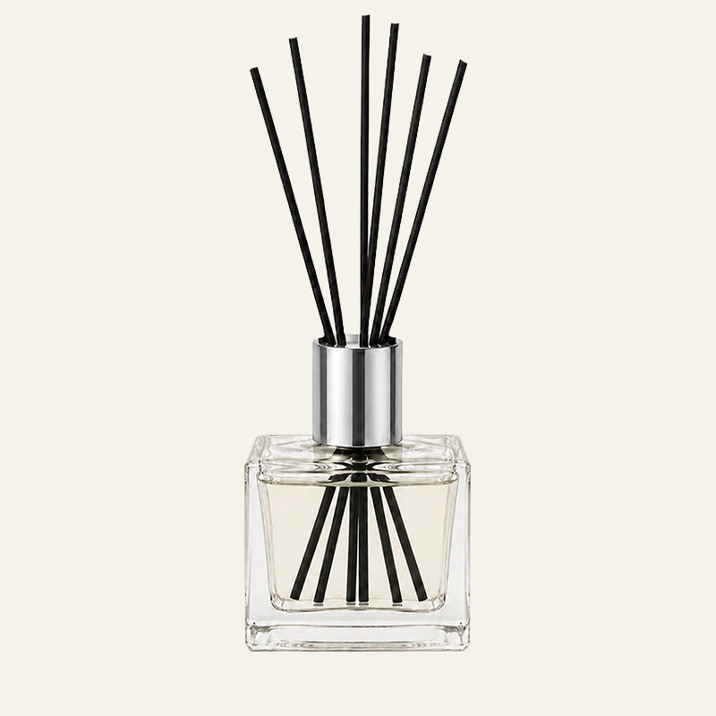 Heavy clear glass diffuser bottle with tall silver collar and black sticks