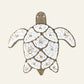 Natural shell turtle wall hanging with white shell pieces, woven rope edging and a loop for hanging.