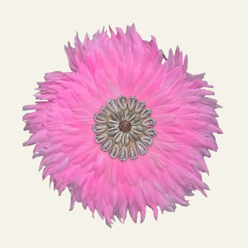Round pink feather and shell Juju wall hanging with natural spiral shell centrepiece.