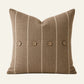 Square cocoa brown French linen cushion cover with fine natural stripes and four coconut buttons.
